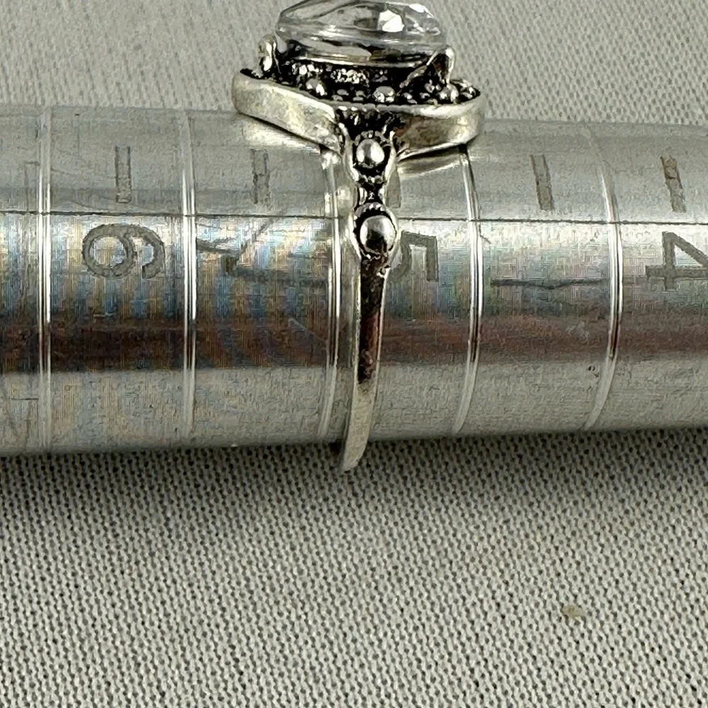 Silver tone ring with a clear teardrop shaped crystal center. - Picture 3 of 4